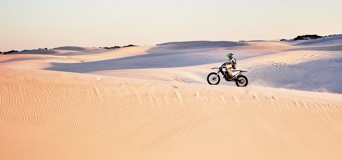 Off-road motorcycle in desert dunes